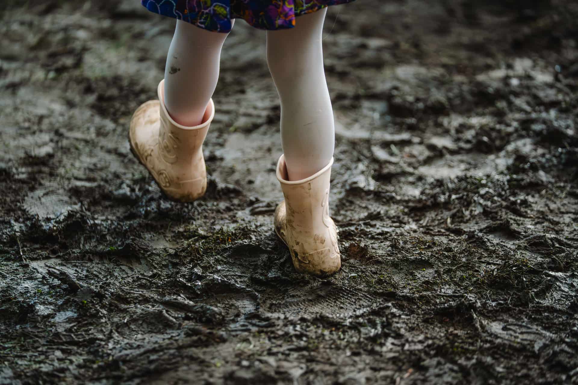 Muddy work boots on wet ground after rain