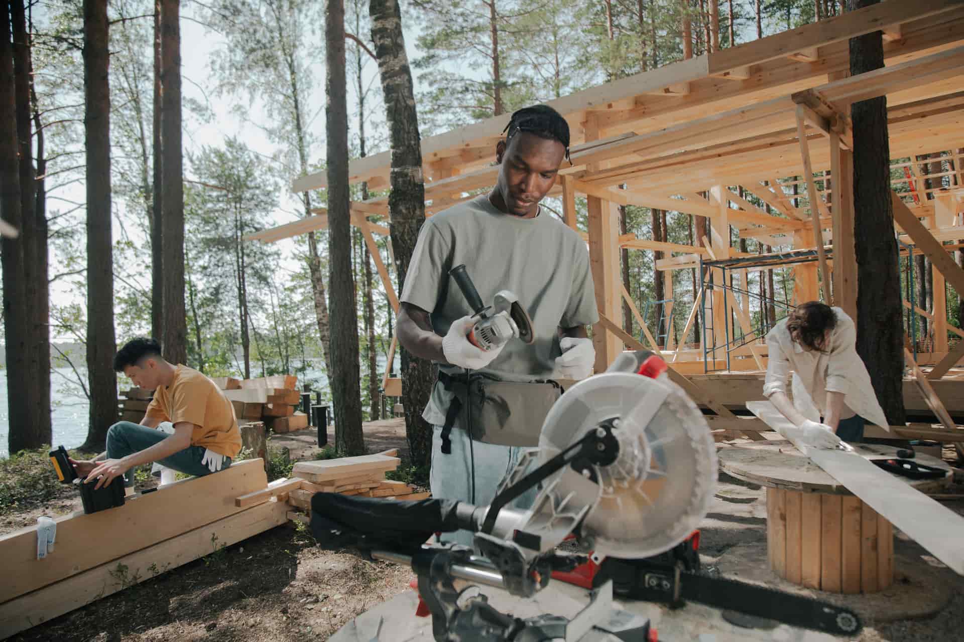 A carpenter framing a timber wall on a construction site