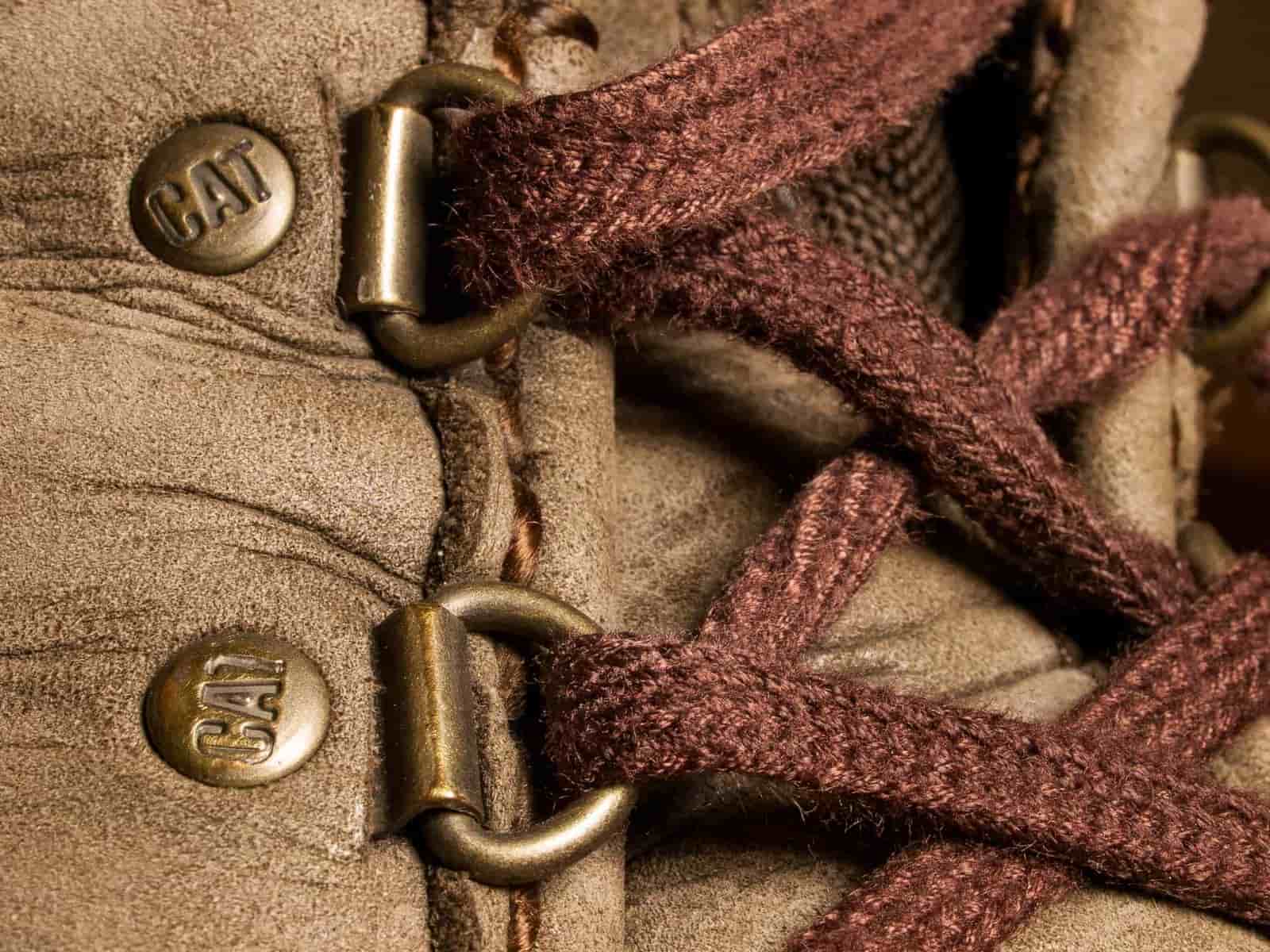 A boot being laced, showing the eyelet row and tongue